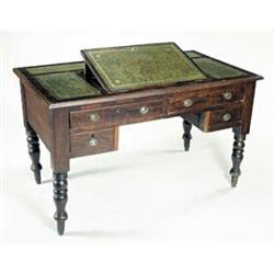 A Victorian mahogany writing table, the crossbanded rectangular top with a moulded edge and an ad...