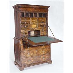 A walnut and marquetry escritoire, the cornice above a cushion shaped drawer, the fall enclosing...