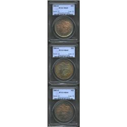 1883-O S$1 MS65 PCGS, orange-gold, powder-blue, and golden-brown patina, lightly rusted dies; 1883-O