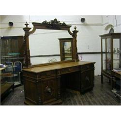 A HISTORICIST OAK SIDEBOARD, c.1880, mirror back, triple frieze drawers, twin pedestals, lion mas...