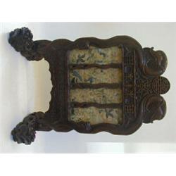 A STRAIGHTS HARDWOOD FIRESCREEN, c.1880, the ends carved as serpents terminating in dragon feet, ...
