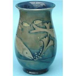 A Moorcroft ovoid vase decorated with fish swimming amongst reeds in a green and blue all over gl...
