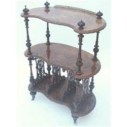 A Victorian figured walnut whatnot-cum-canterbury having 3 moulded shaped shelves and carved turn...