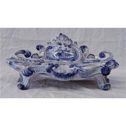 DELFT BLUE AND WHITE POTTERY INKSTAND, Dutch. 19th Century. The shell and scroll molded stand d...