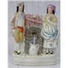 Image 1 : STAFFORDSHIRE POTTERY GROUP, English. 19th Century. Of a man and woman standing next to a well...