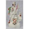 Image 1 : STAFFORDSHIRE POTTERY GROUP, English. 19th Century. Of a Scottish hunter with his hound carryin...