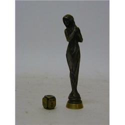 AN ART NOUVEAU BRONZED METAL DESK SEAL, formed as a classically draped maiden, 'A.R' and a cube h...