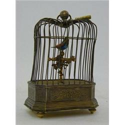 AN AUTOMATON SINGING BIRD IN CAGE, 19th Century French, height 17cm, (with key)  £300-400...