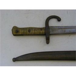 A MILITARY BAYONET, late 19th Century, metal scabbard, ribbed brass grip, length 72cm  £30-40...