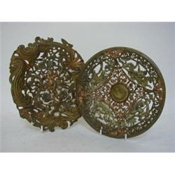 A PAIR OF PIERCED CAST METAL PLAQUES, mid 19th Century, cherub and scrollwork design, and another...