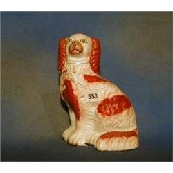 A 19th Century Staffordshire seated figure of a Spaniel 9" (slight crack to front) £30-50...