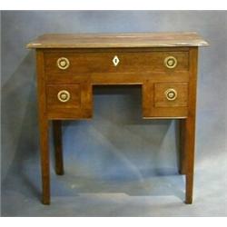 A Georgian oak low boy fitted 1 long and 2 short drawers on square tapering supports with ivory e...