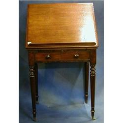 A Georgian mahogany architects table fitted a rising top, the front fitted a brushing slide and w...