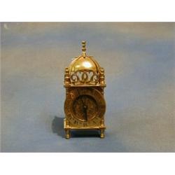 A 1930's brass lantern clock by Smiths 3" £25-35...