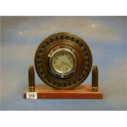 A WWI German aircraft bearing set an 8 day car clock and supported by 2 canon shells £40-60...