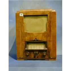 A 1930's radio by Harrods contained in a walnutwood case  15" £20-30...