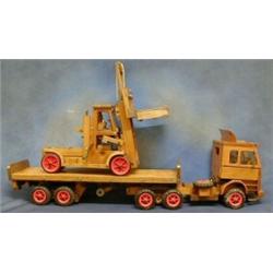 A wooden model of a Scania tractor unit and trailer together with a fork lift truck £150-200...