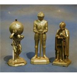 An aluminium table light in the form of Atlas and 2 other table lighters in the form of standing...