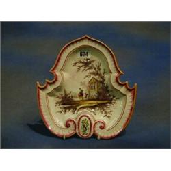 A 19th Century shaped faience plate decorated a Punch and Judy theatre, the reverse marked VP, 9"...