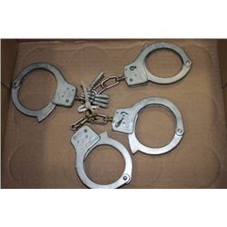 2 SETS OF HANDCUFFS AND KEYS
