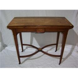 EDWARDIAN ROSEWOOD CARD TABLE,top with a central floral motif with similar banded edge, on taperi...