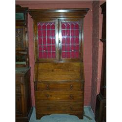 ARTS AND CRAFTS STYLE OAK BUREAU BOOKCASE,with leaded glass doors,over three long drawers with dr...