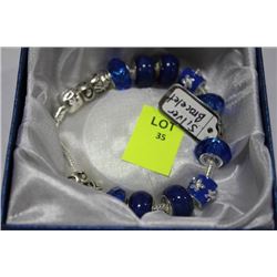 SILVER CHARM GLASS BRACELET W/ BLUE STONES
