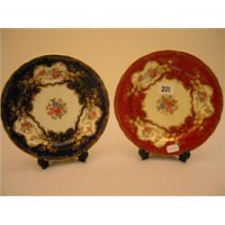 Two Aynsley plates with handpainted floral decoartion and gilt borders, one on red ground, other …