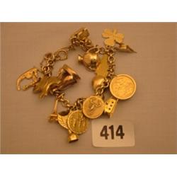 9ct gold bracelet with 18ct gold charms 22ct gold sovereign and Georgian gold seal 56gms in weigh…