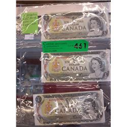 3 Mint Canadian $1 bank notes in sequence.