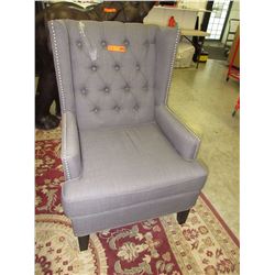 New - Grey upholstered wing backed chair - as is