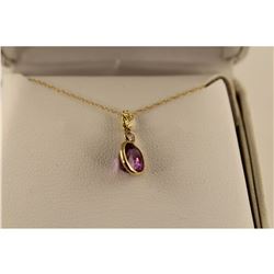 ONE 14KT YELLOW GOLD NATURAL PURPLE SAPPHIRE AND DIAMOND SET PENDANT. SET WITH ONE OVAL MIXED CUT