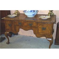 Antique Queen Anne style crossbanded walnut veneered kneehole side table having a shaped apron an...