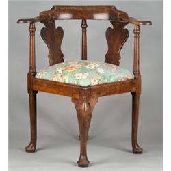George III walnut corner chair having scroll arms and vase shaped back splats, padded seat on fro...
