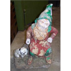 Late 19th/early 20th Century terracotta garden gnome, the bearded figure seated on a tree trunk a...