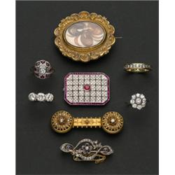 Gold ring set central diamond within a diamond set eight pointed star design surround, each point...