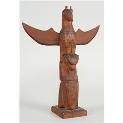 Northwest Coast Totem Carved with a Thunderbird and Sea Bear Holding a Fish Attributed to Arthur Sha