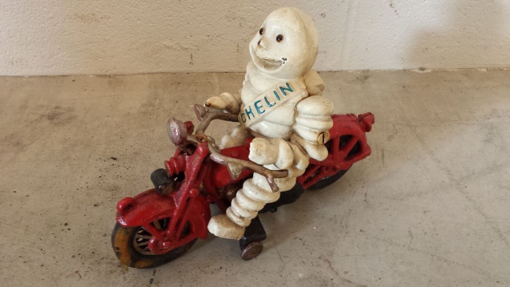 Cast Iron Ornament Michelin Man on Red Motorcycle like Harley Davidson Cast Iron Ornament Michelin Man on Red Motorcycle like Harley Davidson