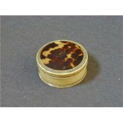 A CIRCULAR IVORY LIDDED BOX, George III period, inset tortoiseshell disk, diameter 5.5cm 50-60...
