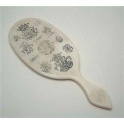 An early Victorian ivory hand mirror with heraldic engraving, engraved overall with a Ducal crown...