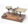 Image 1 : A large late Victorian brass postal scale, on oak base, with seven weights, 13ins wide...