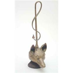 A Victorian brass fox door-stop, with whip above on an iron base, 18ins...