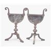 Image 1 : A pair of aesthetic movement andirons, with half moon tool rests cast with foliage on three legs,...