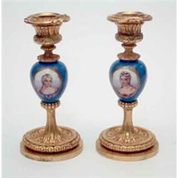 A pair of Sevres pattern porcelain and gilt bronze candlesticks, each porcelain knop painted with...