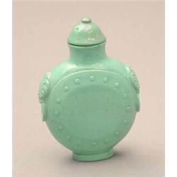 A turquoise matrix snuff bottle, of disc shape, animal mask ring handles, 2.25ins, 20th century m...