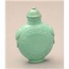 Image 1 : A turquoise matrix snuff bottle, of disc shape, animal mask ring handles, 2.25ins, 20th century m...