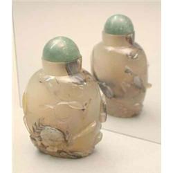 An agate snuff bottle, carved with a crab and a bird among rocks (small chip), 19th century, stop...