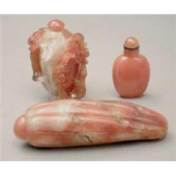 A red and white agate (cornelian) snuff bottle, deeply carved with prunus blossom, 2.25ins; a pla...