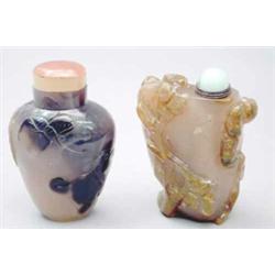 Two mottled grey, brown and green block agate snuff bottles, one carved in relief with a cat and...