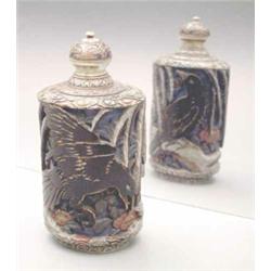 An ivory polychrome table snuff bottle, carved in high relief with two birds among flowering bran...